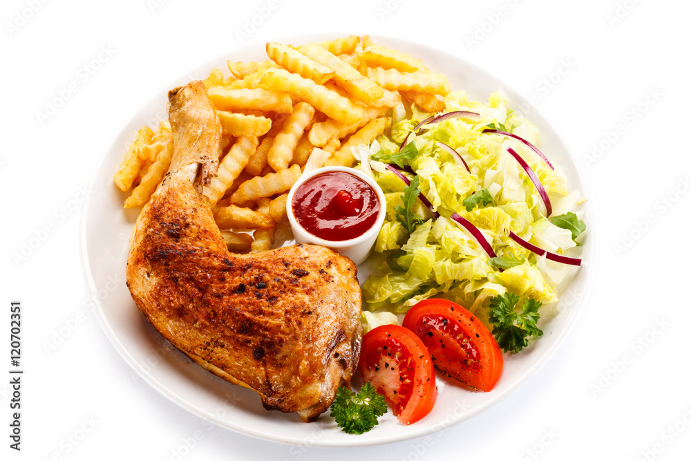 Grilled chicken legs with chips and vegetables Grilled chicken legs with chips and vegetables