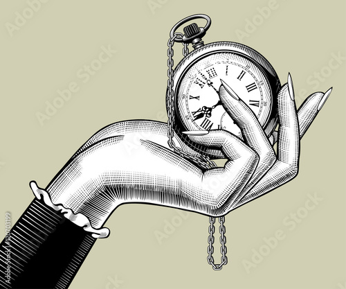 Woman's hand with a retro pocket watch