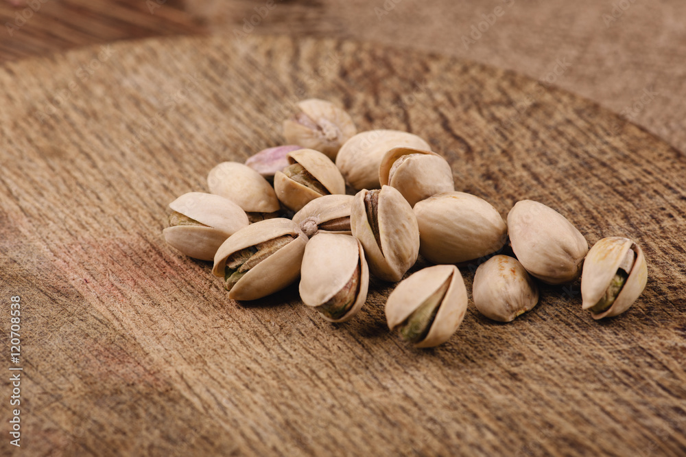 pistachios on a wooden table closeup top view pistachios on a wooden table closeup top view
