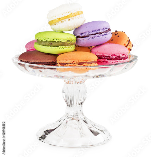 macaroons on a glass cake stand isolated on white
