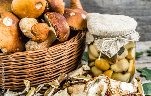 Autumnal mushrooms, boletus marinated in jar and dry mushroom on