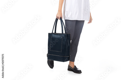 Woman holding a handbag isolated on white background