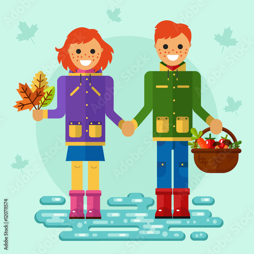 Flat design vector illustration of funny smiling boy and girl in jackets and rubber boots holding their hands. Including autumn symbols: basket with vegetables, bunch of leaves, leaf fall, puddle.
