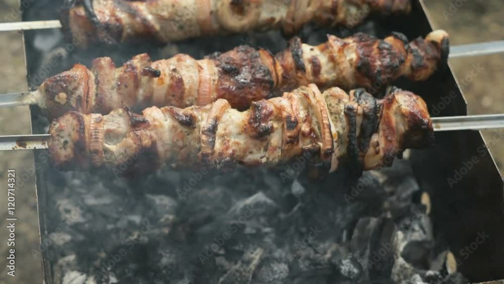 Meat are prepared on the metal skewers on a grill Meat are prepared on the metal skewers on a grill