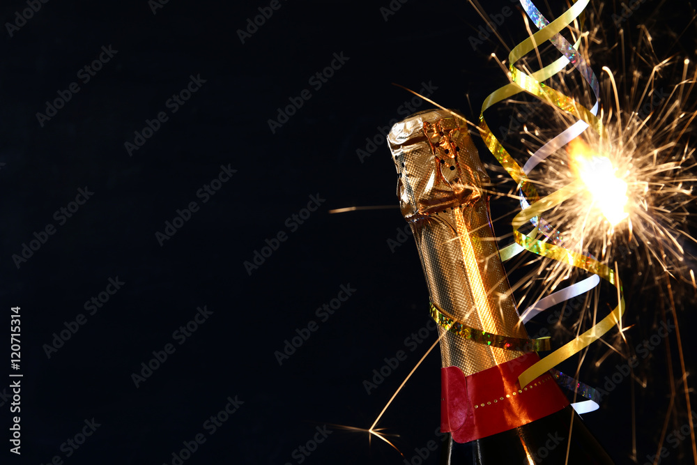 Champagne bottle in front of black background Champagne bottle in front of black background