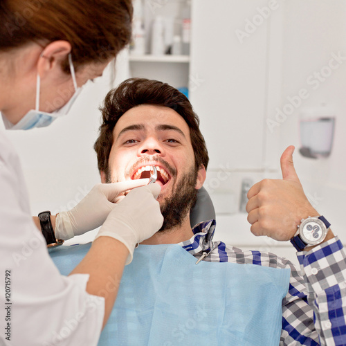 young happy man and woman in a dental examination at dentist