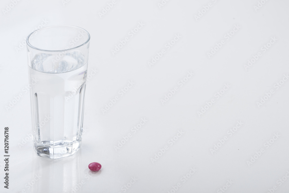 Glass of water and pills isolated on white Glass of water and pills isolated on white