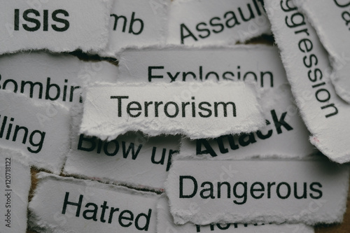 Torn paper with terrorism related words.