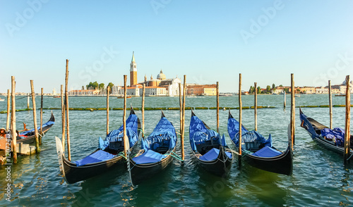 Gondolas moored by Saint Mark square with San Giorgio di Maggior © farbregas1987