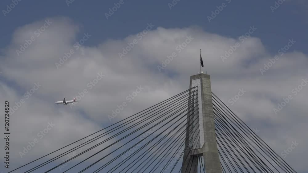Airplane flying by the ANZAC Bridge in Sydney