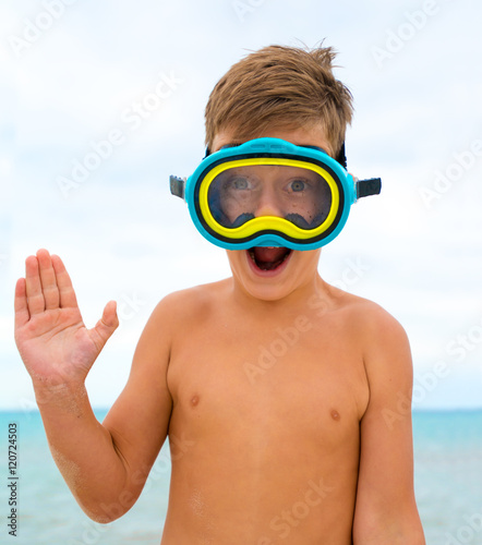 Child on the beach with swimming mask.