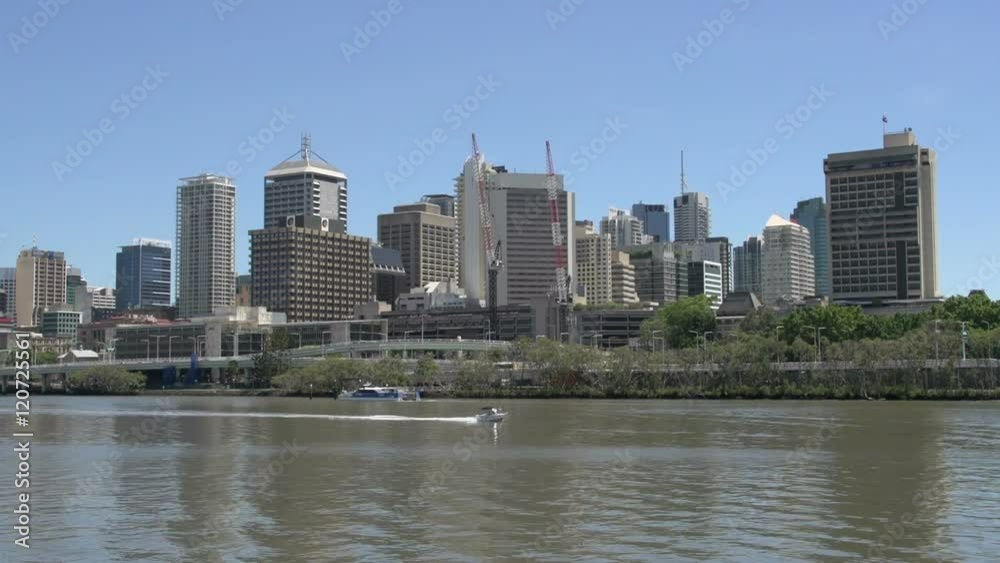 Small speedboat in front of the brisbane skyline Small speedboat in front of the brisbane skyline