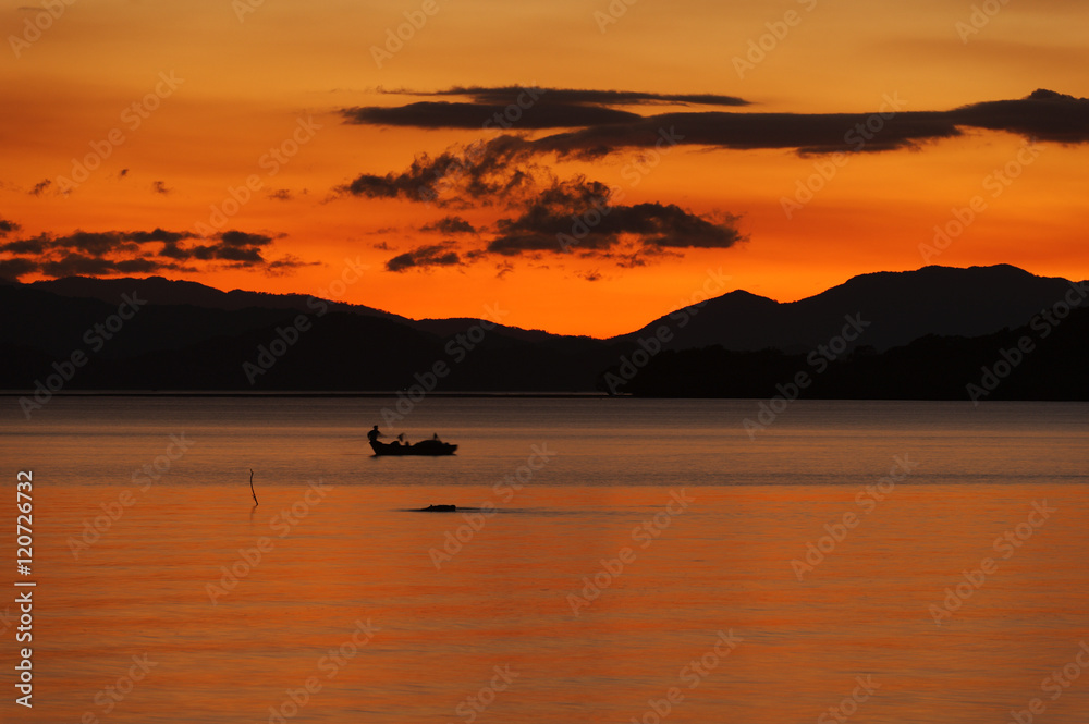 Lonely fisherman in the Nicoya Gulf after sunset. Lonely fisherman in the Nicoya Gulf after sunset.