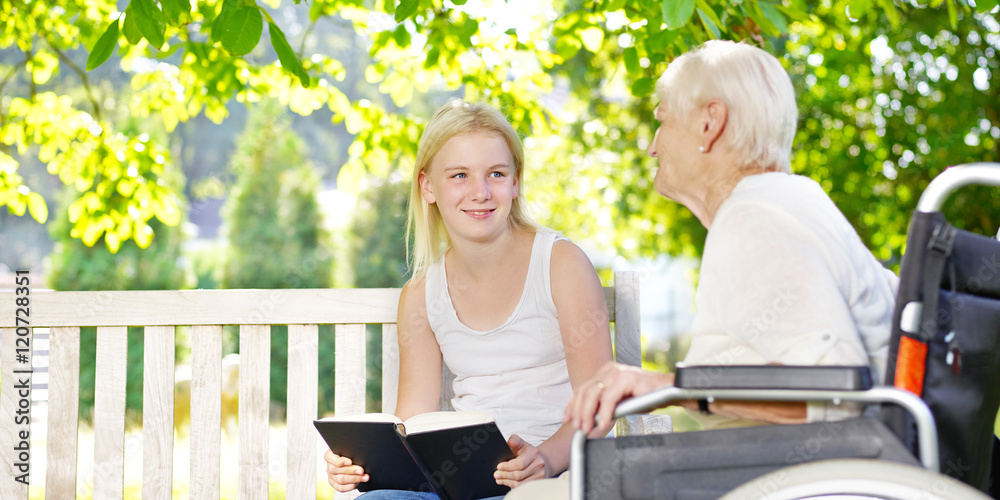 Girl and her grandmother reading a book Girl and her grandmother reading a book