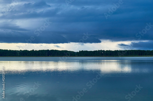 Dramatic Storm Clouds over beautiful Lemiet lake in Mazury district, Poland. Fantastic travel destination.
