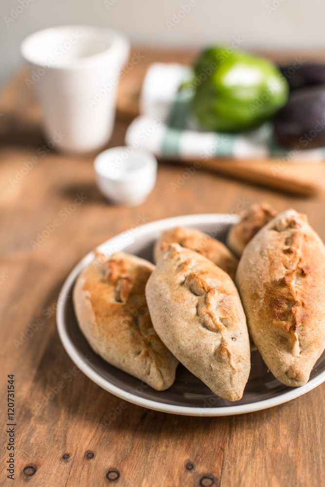 Hot pies with mushrooms on plate, vegetable calzone Hot pies with mushrooms on plate, vegetable calzone