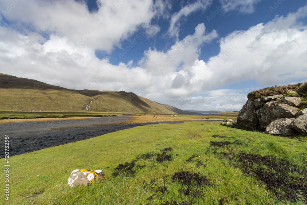 Beautiful scenery in Scotland. River flows through a green valley. Green mountainside in the background. Beautiful scenery in Scotland. River flows through a green valley. Green mountainside in the background.