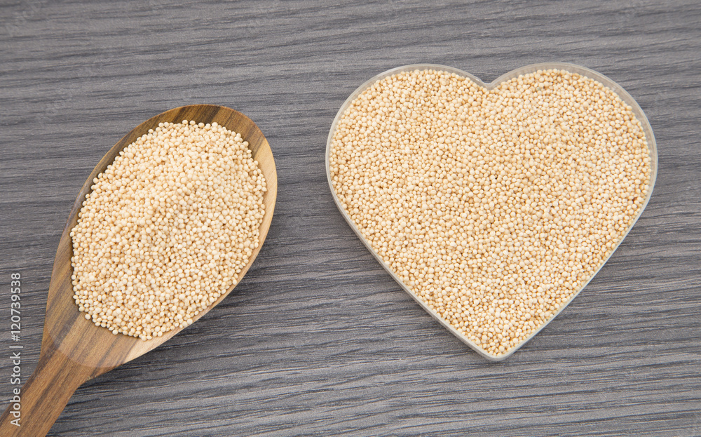 Amaranth seeds in the spoon and bowl-shaped heart Amaranth seeds in the spoon and bowl-shaped heart