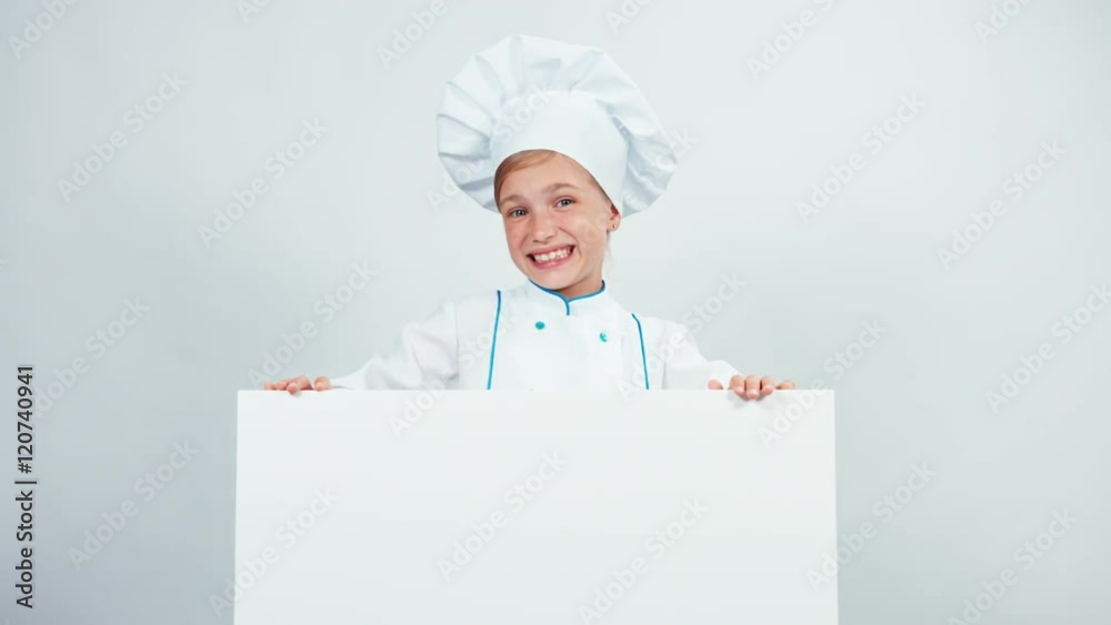 Portrait laughing little chef cook in cap with white board isolated on white looking at camera Portrait laughing little chef cook in cap with white board isolated on white looking at camera
