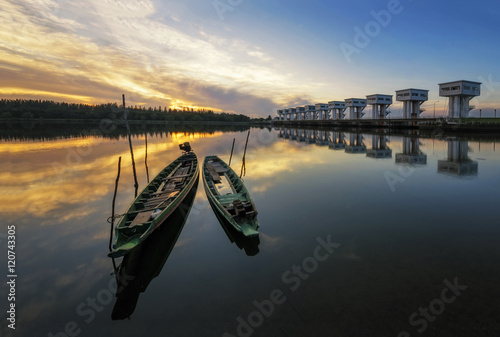 The bright sky a beautiful golden color at Uthokawiphatprasit Watergate, Pak Phanang, Nakhon Si Thammarat Diversion Dam Project is a project specifically approved by His Majesty the King of Thailand photo