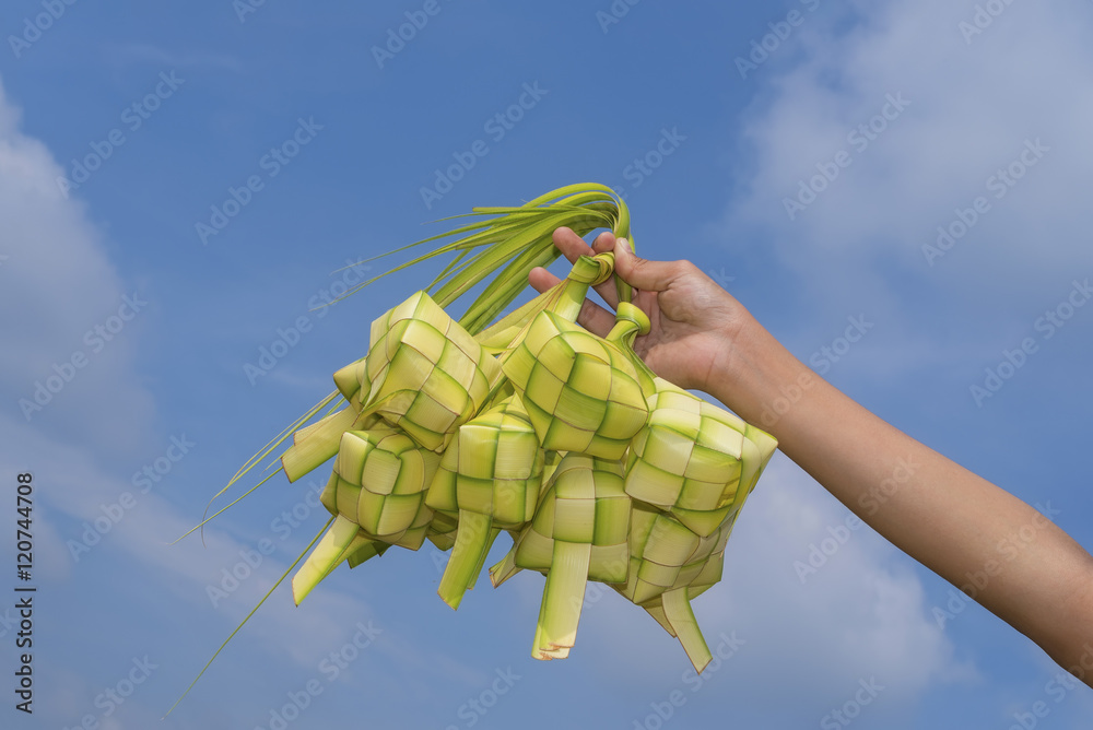 custom made wallpaper toronto digitalA hand holding Ketupat - Malay cuisine made from glutinous rice packed inside a diamond shaped container of wooven palm leaf.