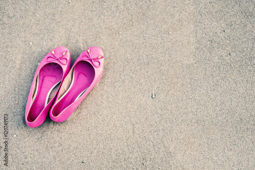 Pink feminine shoes on a sandy beach, Film simulation