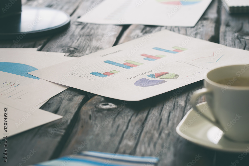 Desktop with quarterly reports and graphs of sales Desktop with quarterly reports and graphs of sales
