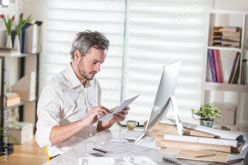 An architect sitting at office and working an a building project