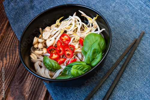 Vegetarian vietnamese style soup pho with chopsticks. Traditional asian cuisine. photo