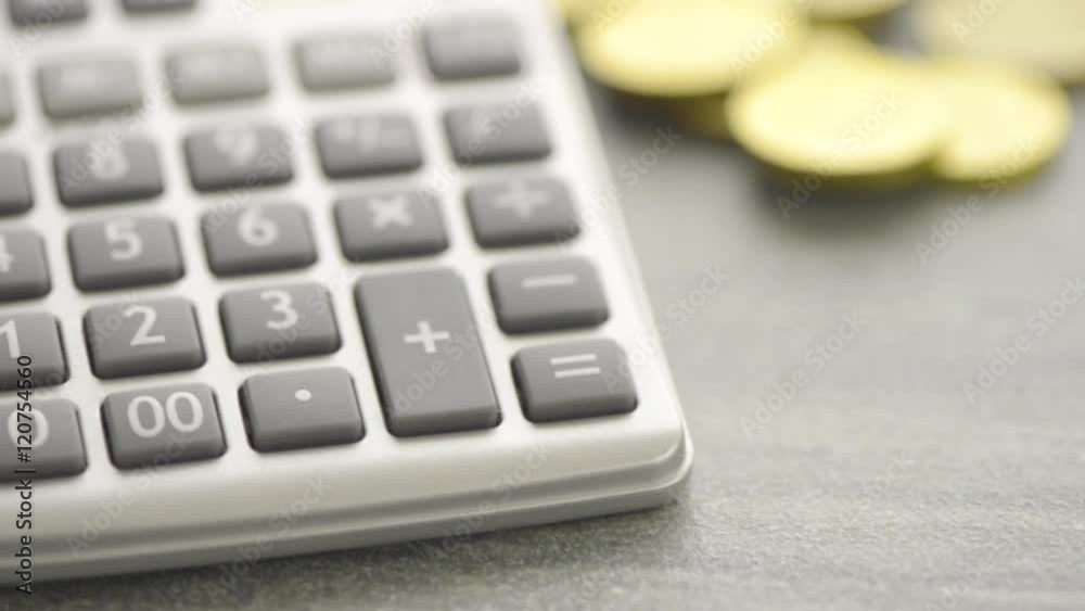 Calculator, coins and notepad on office desk. Film clip with slow sliding motion. Concept of economy, budget and home finances. Calculator, coins and notepad on office desk. Film clip with slow sliding motion. Concept of economy, budget and home finances.