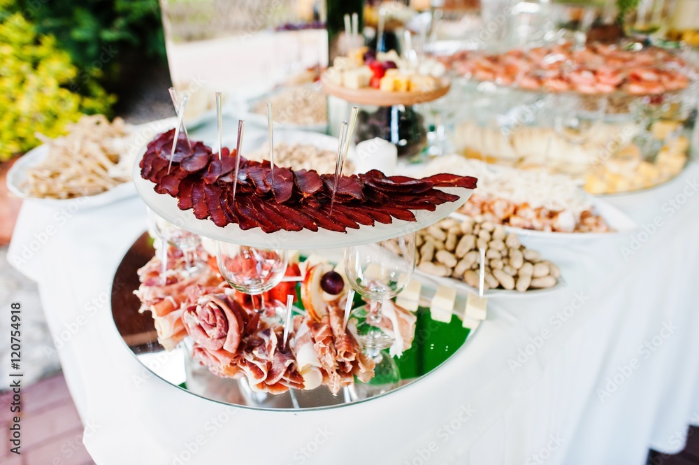 Elegance wedding reception table with food and decor. Basturma and ham