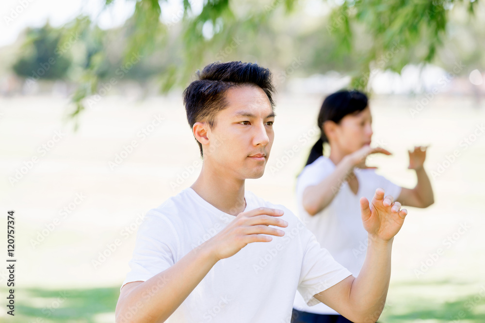 People practicing thai chi in park People practicing thai chi in park
