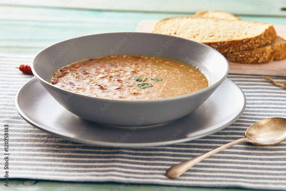 bean and spelt soup on a wooden table, bright colors bean and spelt soup on a wooden table, bright colors