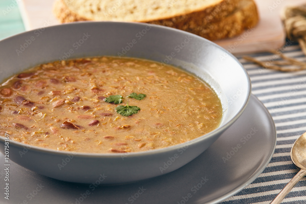 bean and spelt soup on a wooden table, bright colors bean and spelt soup on a wooden table, bright colors