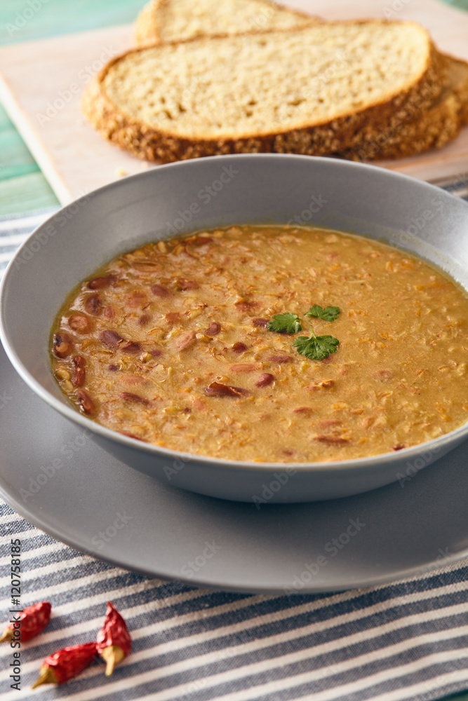 bean and spelt soup on a wooden table, bright colors