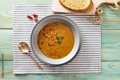 bean and spelt soup on a wooden table, bright colors