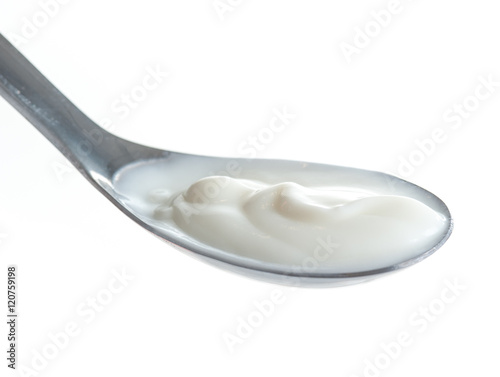 Spoon of milk cream isolated on white background