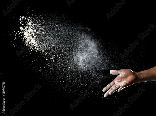 Fototapeta Hand and flour on black background