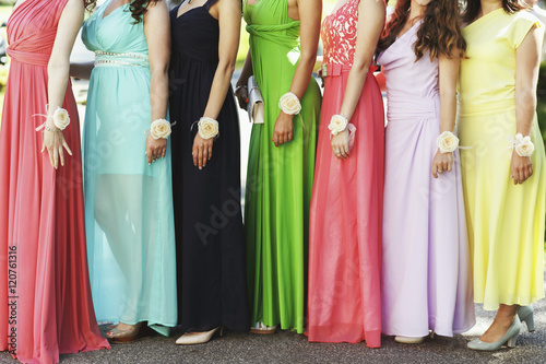 Happy bridesmaids in multicolored dresses