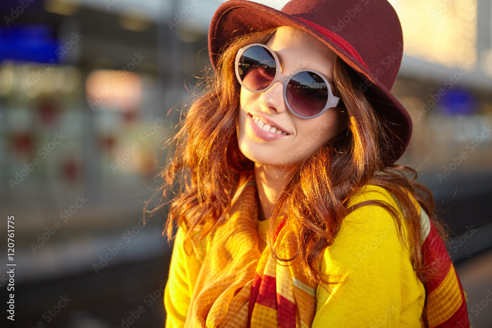 Pretty young woman at a train station (autumn toned image) Pretty young woman at a train station (autumn toned image)