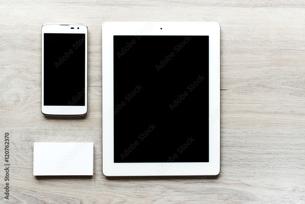 Top view of man set: devices phone, tablet, business card on white wooden table. Set of men's accessories. View from above top view with copy workspace. Top view of man set: devices phone, tablet, business card on white wooden table. Set of men's accessories. View from above top view with copy workspace.