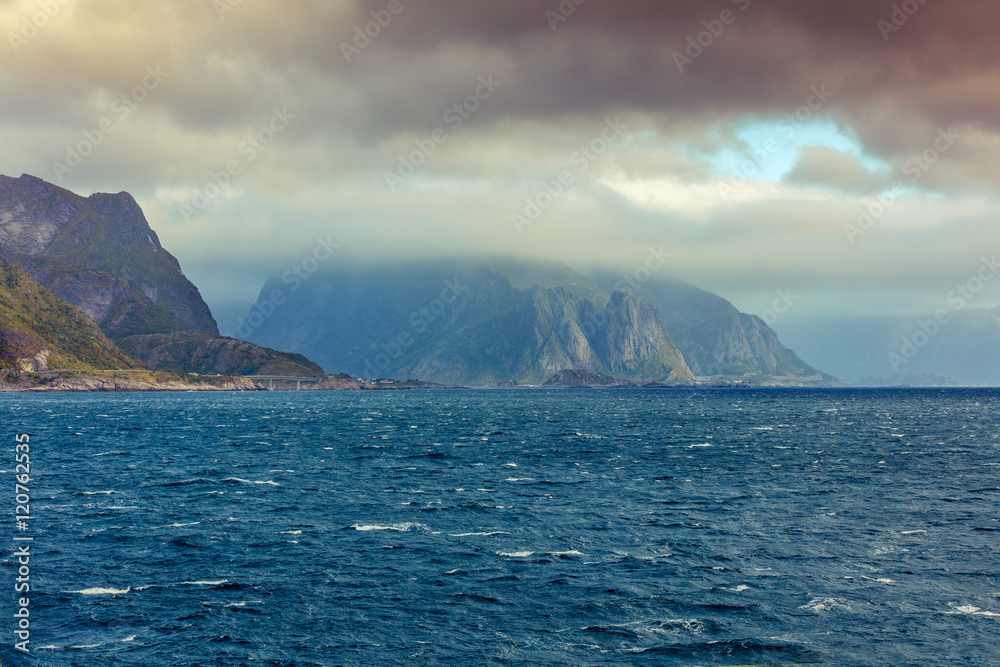 Rocky Lofoten islands sea shore with dramatic sky