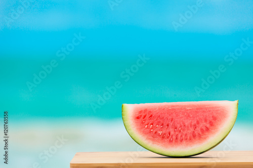 Slice of watermelon on the beach. 