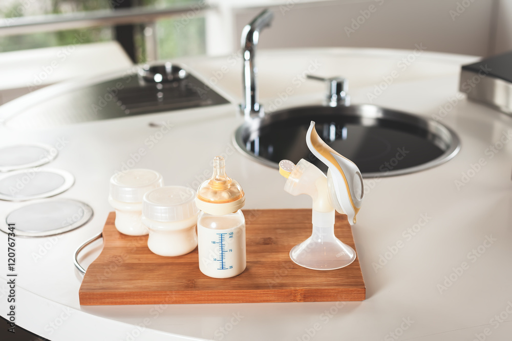 Baby bottle with milk and manual breast pump Baby bottle with milk and manual breast pump