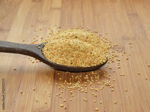 A spoonful of dried whole sesame seeds, one of the most ancient spices used in bakery and confectionery products