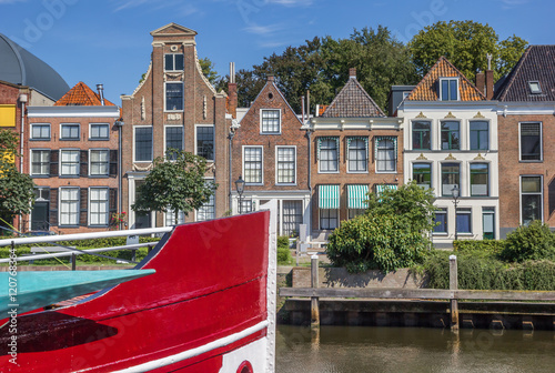 Bow of a red ship and historical houses in Zwolle photo