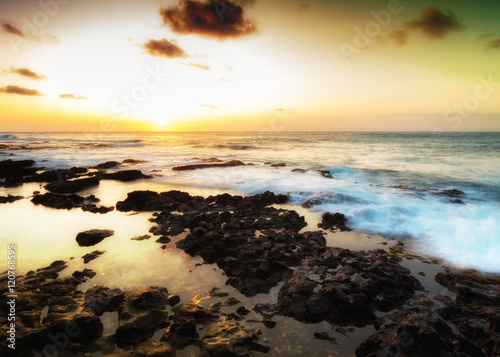 Colorful sunrise on a rocky beach outside Honolulu, Hawaii © Allen.G