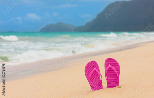 Pair of sandals on a beautiful white sand beach. (location Hawaii) 