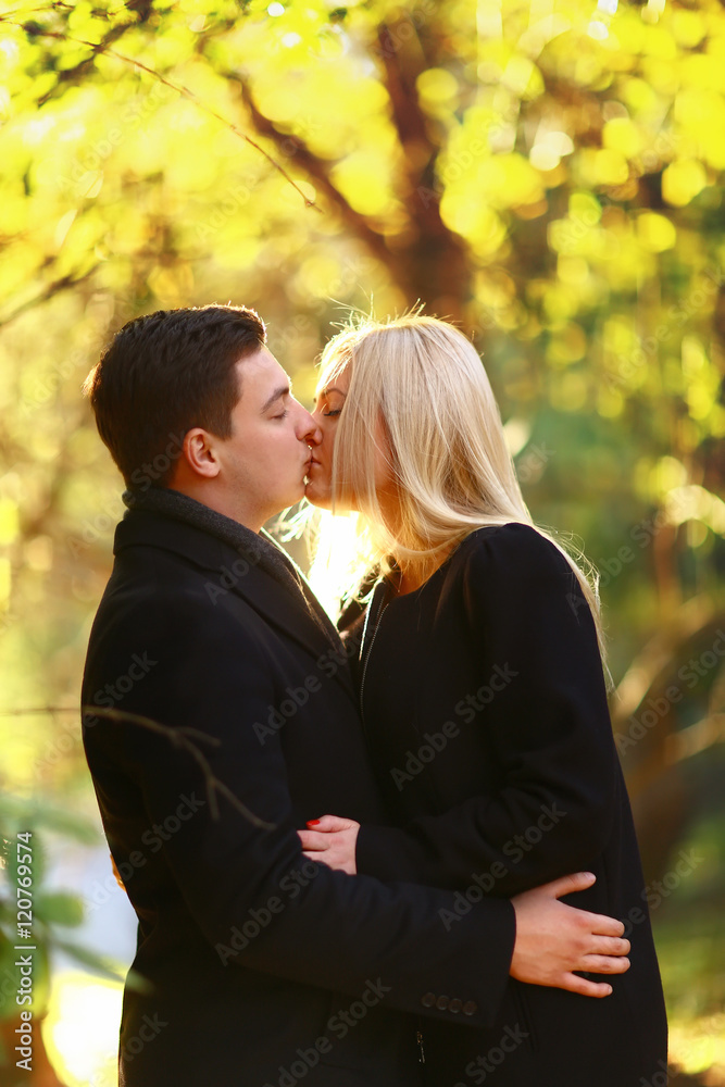 Fototapeta premium Beautiful young couple walking in the autumn park