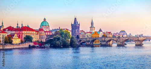 Sunset landscape view to Charles bridge on Vltava river in